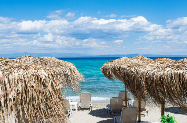 Straw umbrellas at the beach with seaside view