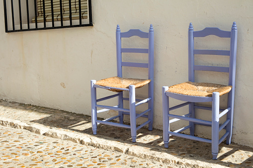 Detail of traditional mediterranean wooden chairs on the street in Altea, Alicante, Spain.