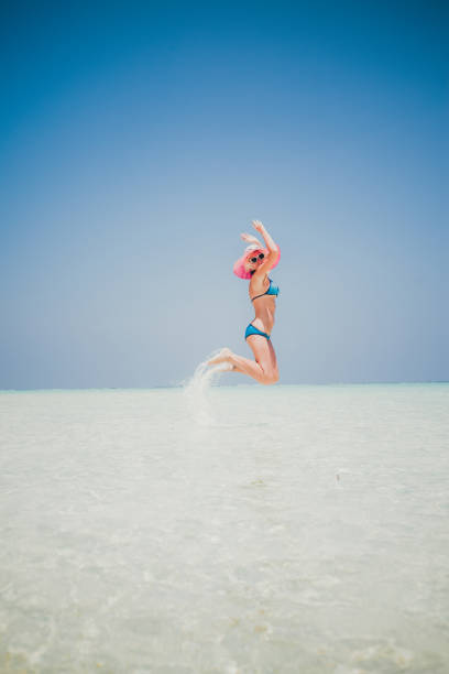 istock Woman jumping on the beach, Maldives 802630538