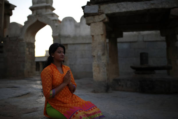 istock Young Lady Praying to the Hindu God 802630620