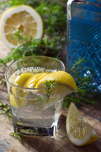 Cocktail with blue gin , tonic and lemon .