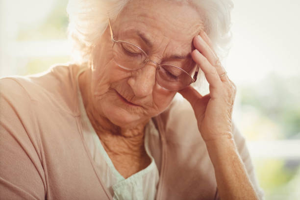 istock Elderly woman with headache 802649734
