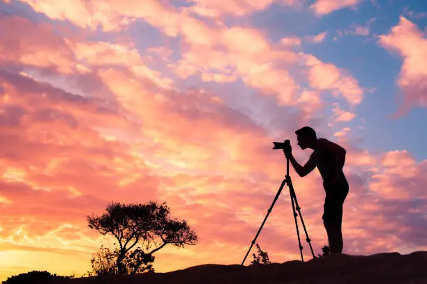 Photo of Male photographer taking photos in a beautiful nature setting.