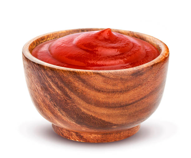istock Ketchup in wooden bowl isolated on white background 802654162