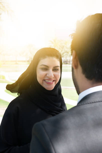 istock Arab businessman and woman having conversation 802662388