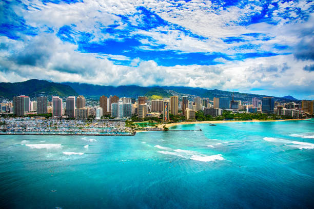 Downtown Skyline of Honolulu Hawaii The beautiful coastline Honolulu Hawaii shot from an altitude of about 500 feet during a helicopter photo flight over the Pacific Ocean. honolulu marina oahu stock pictures, royalty-free photos & images