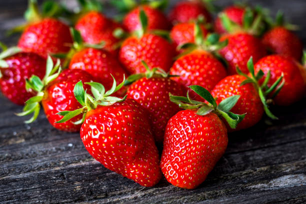 istock Fresh strawberry on wooden background 802671200