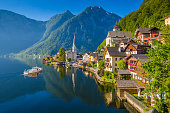 Classic view of Hallstatt with ship at sunrise, Salzkammergut, Austria