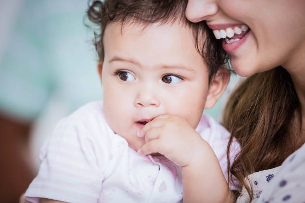 istock Beautiful baby held by her mother 802674352