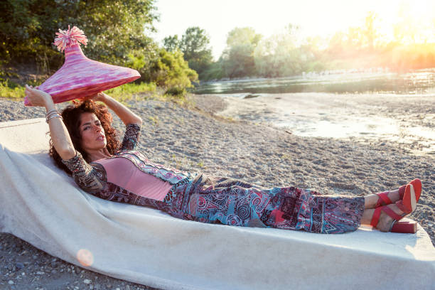istock Beautiful woman plays with her straw hat 802693096