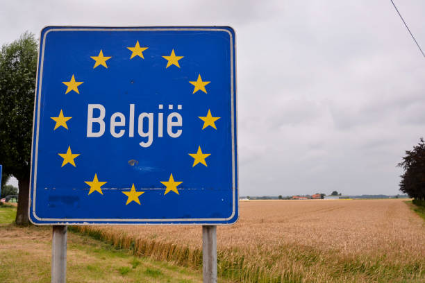 road sign indicating the border of belgium - alb imagens e fotografias de stock