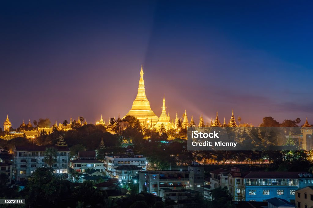 Aerial View Yangon Night Shwedagon Pagoda Myanmar Aerial view over Yangon City towards the famous golden illuminated Shwedagon Pagoda at Dusk - Twilight, skyline cityscape view from above. Yangon, Rangoon, Myanmar, Burma, Asia. Yangon Stock Photo