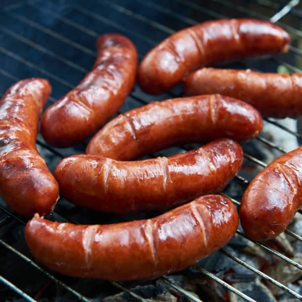 istock Sausages on a barbecue grill. Fried sausages 802735470