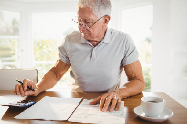 istock Worried senior man with tax documents 802743080