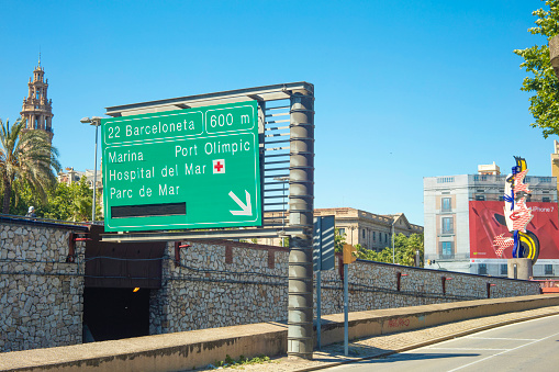 Barcelona, Spain - May 25, 2017: Street sign showing the exit to Barceloneta, Marina Street, Port Olimpic and Hospital del Mar in Barcelona, Spain.