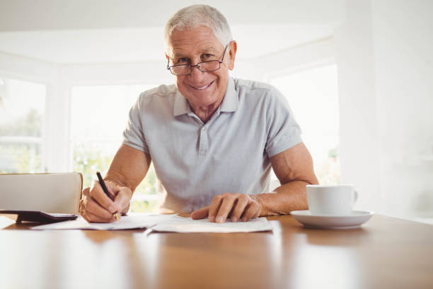 istock Worried senior man with tax documents 802745198
