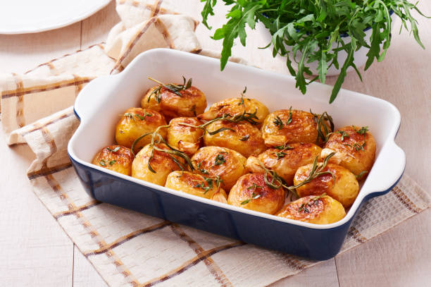 istock Roasted potatoes with garlic, thyme and rosemary in ceramic baking dish 802745276