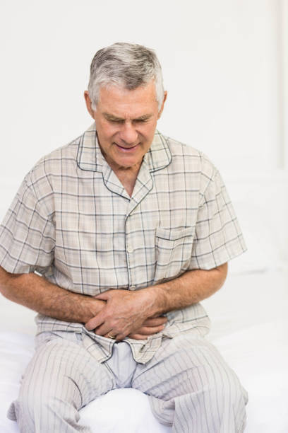 istock Suffering senior man holding his belly 802745572