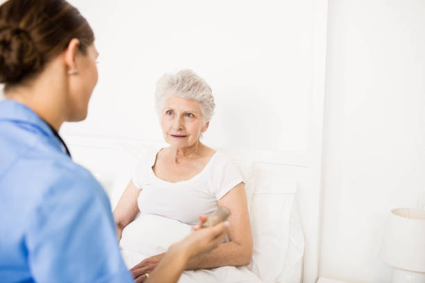 istock Nurse taking care of suffering senior patient 802763550