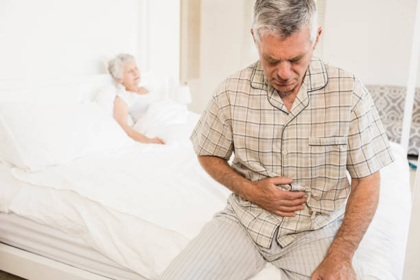 istock Suffering senior man holding his belly 802763682