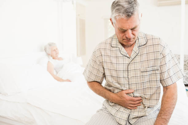 istock Suffering senior man holding his belly 802763686