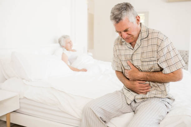 istock Suffering senior man holding his belly 802763714