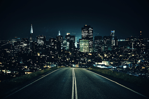 A highway at night with light trails in motion from traffic