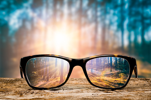 glasses focus background wooden eye vision lens eyeglasses nature reflection look looking through see clear sight concept transparent sunrise prescription sunset vintage sunny sun retro - stock image