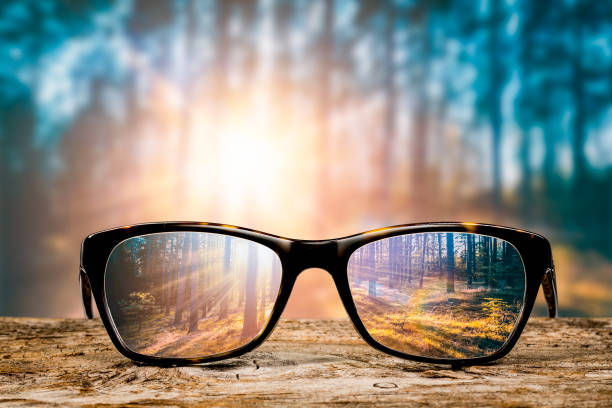 Glasses concepts. glasses focus background wooden eye vision lens eyeglasses nature reflection look looking through see clear sight concept transparent sunrise prescription sunset vintage sunny sun retro - stock image focus concept stock pictures, royalty-free photos & images