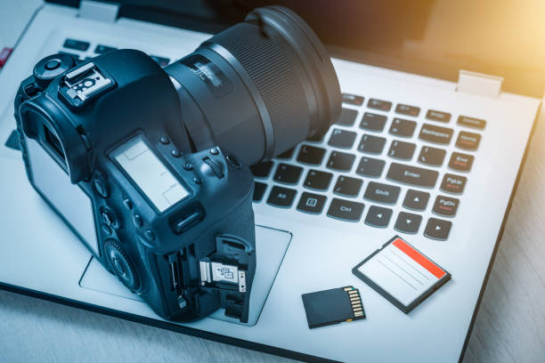 Modern digital DSLR camera. Photography concept. Modern digital DSLR camera and computer workstation. Photography and videography concept. photo editor photos stock pictures, royalty-free photos & images