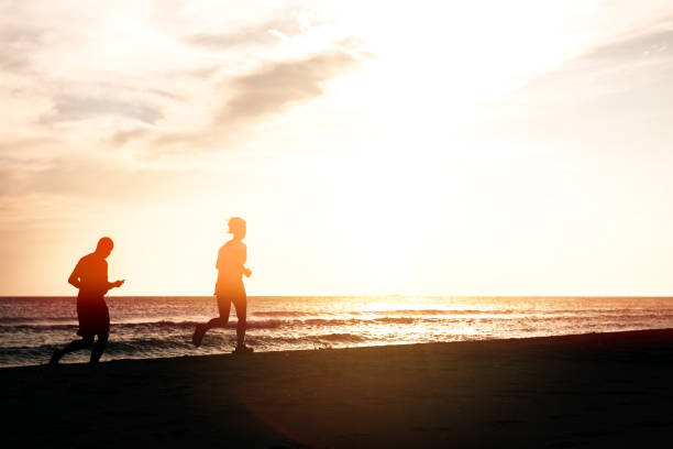 istock Workout of two runners on the beach 802780616