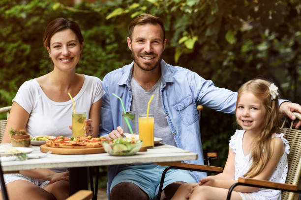 istock Happy Family eating in a restaurant 802791216