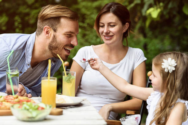 istock Happy young family eating at a restaurant 802791244