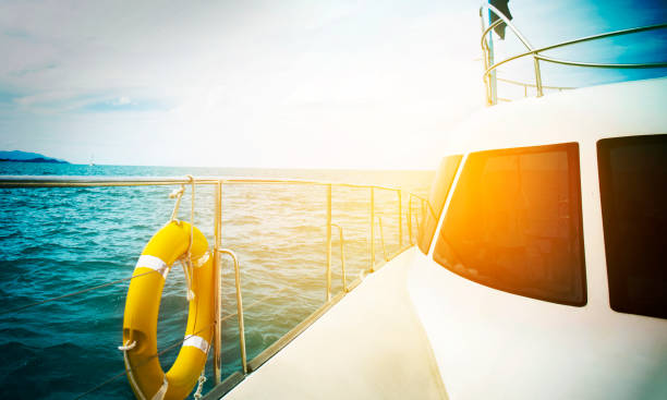 istock Sail boat gliding in open sea at sunset 802798846