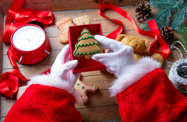 istock Santa Claus have wrapping a Christmas cookie 802801624