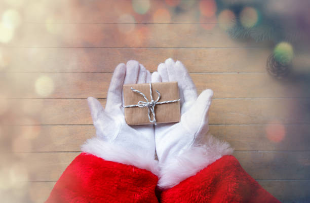 istock Santa Claus got a gift and holding it 802801638