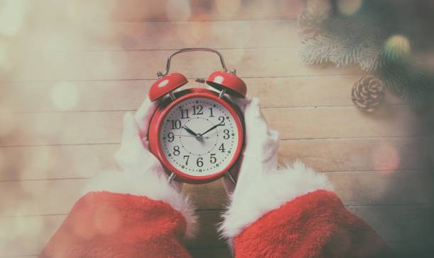 istock Santa Claus holding Chrstmas alarm clock 802801644