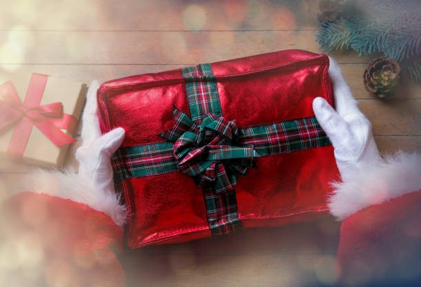 istock Santa Claus have wrapping a Christmas box 802801650