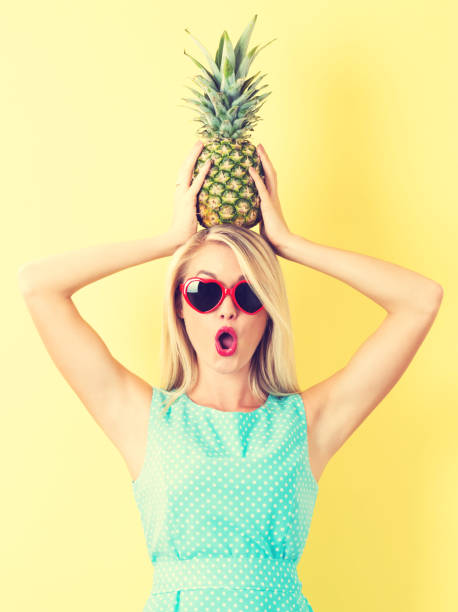 istock Happy young woman holding a pineapple 802801748