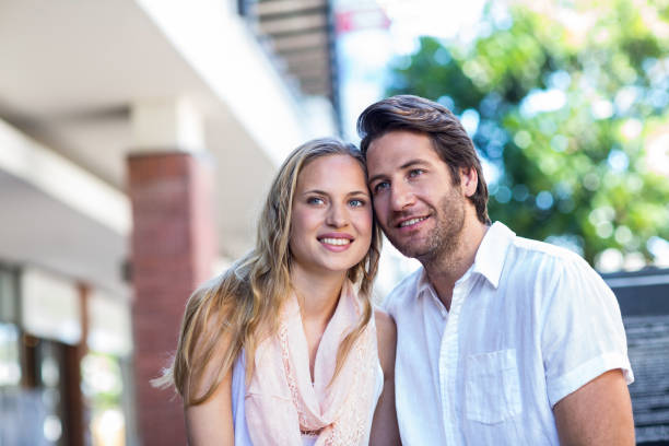istock Smiling couple sitting closely together 802814768