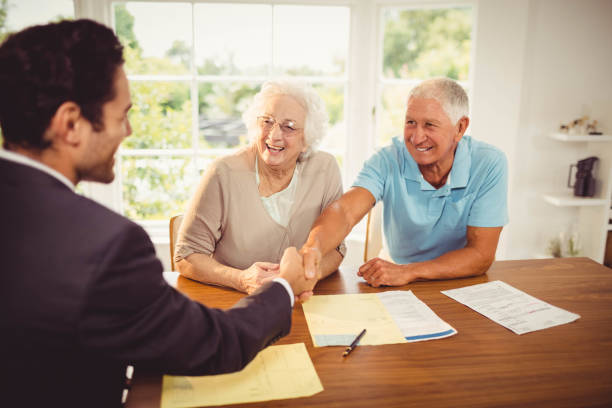 istock Businessman and senior man handshaking 802819544