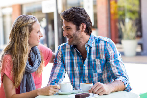istock Young happy couple smiling at each other 802830262