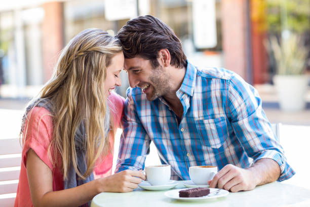 istock Cute couple sitting at a cafe head to head 802830286