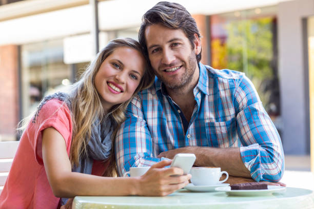 istock Smiling couple having tea in a cafe 802830436