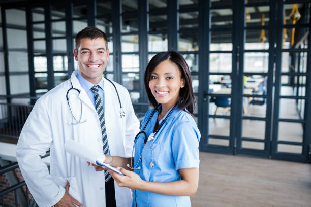 istock Nurse and doctor smiling at camera 802832916