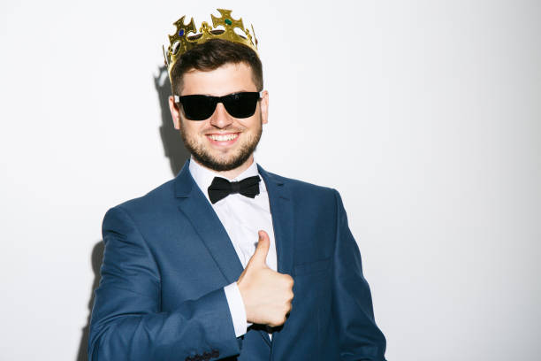 istock Man in crown showing thumbs-up 802835614