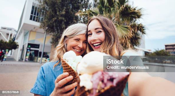 Senior Mother And Daughter Taking A Selfie While Eating Icecream Stock Photo - Download Image Now