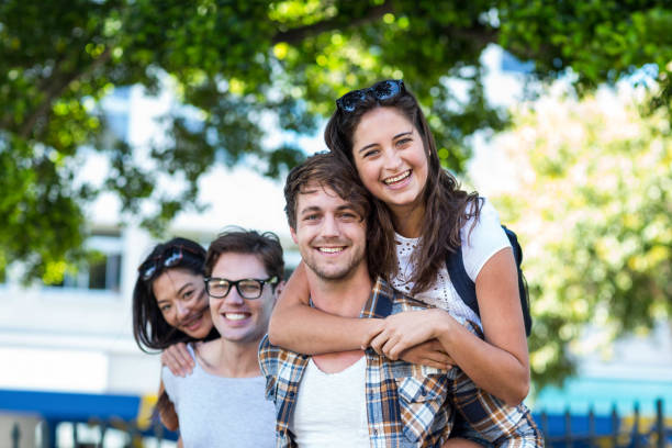 istock Hip men giving piggy back to their girlfriends 802843834