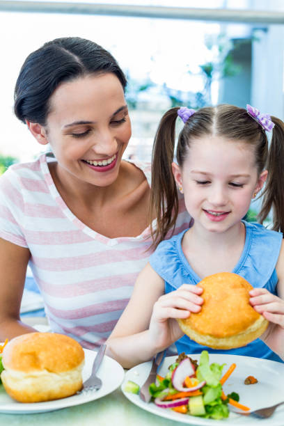 istock Daughter and mother eating at the restaurant 802845930