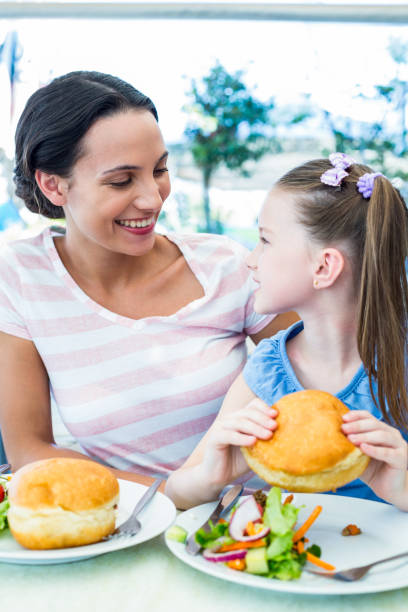 istock Daughter and mother eating at the restaurant 802845946